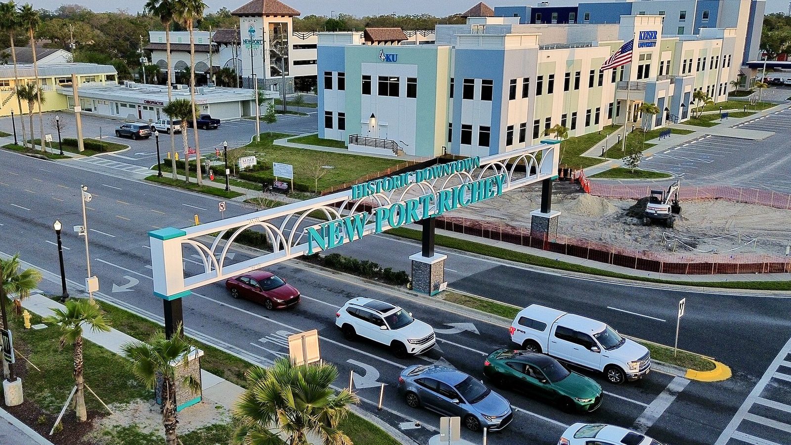 The Historic Downtown New Port Richey arch over Main Street with traffic passing beneath